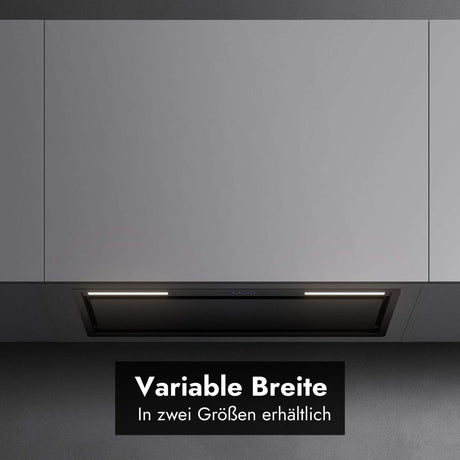 Frontale Detailansicht des bündig integrierten Falmec Lüfterbausteins Plus Green Tech unter glatten, hellgrauen Oberschränken mit aktivierter LED-Beleuchtung. Im unteren Bereich zeigt ein schwarzes Grafik-Overlay den Text "Variable Breite" sowie den Untertitel "In zwei Größen erhältlich".